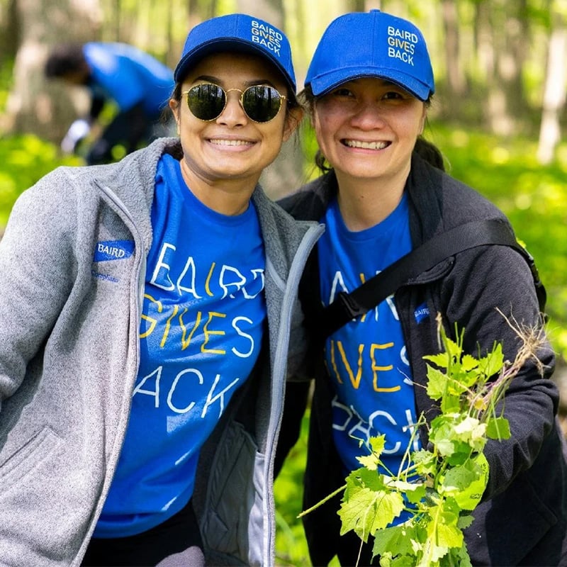 Two SilverPeak Strategic Capital associates volunteering outdoors during in SilverPeak Strategic Capital Gives Back apparel