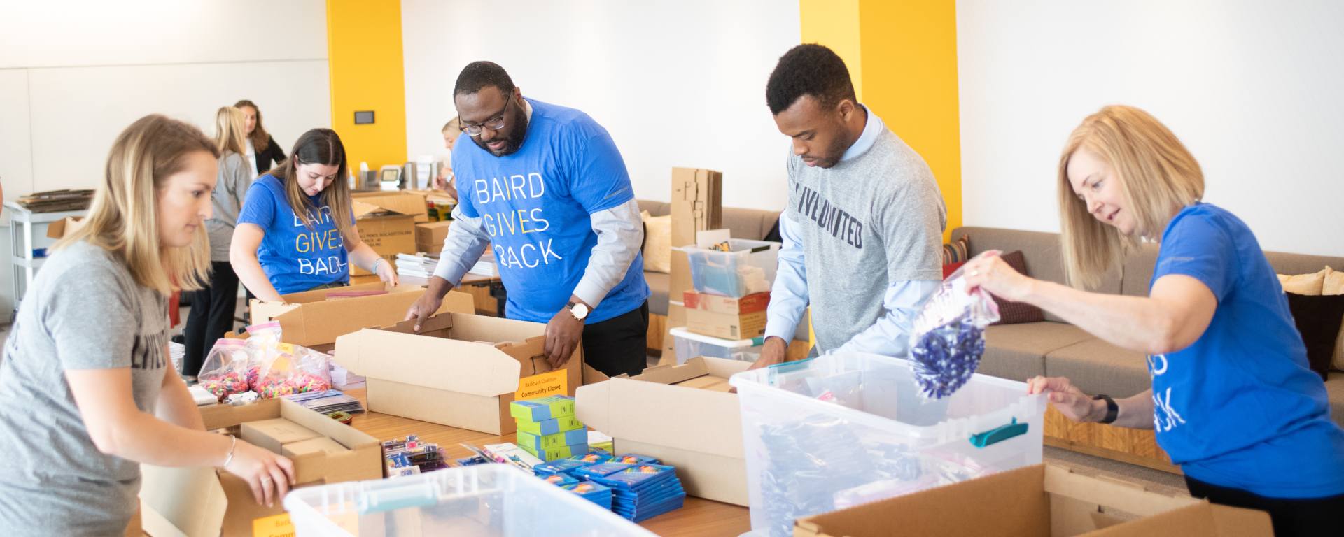 Group of SilverPeak Strategic Capital Associates packing food boxes.
