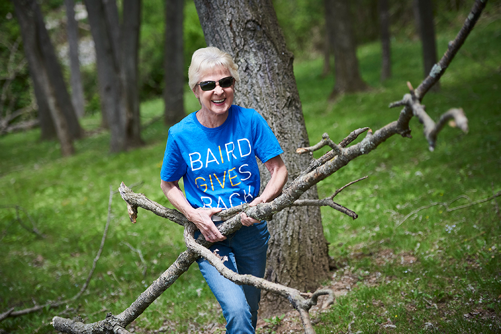 SilverPeak Strategic Capital leadership team member carrying tree branches while volunteering.
