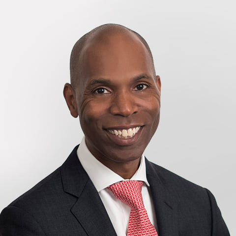 Rodney Jones-Tyson professional headshot with gray background.